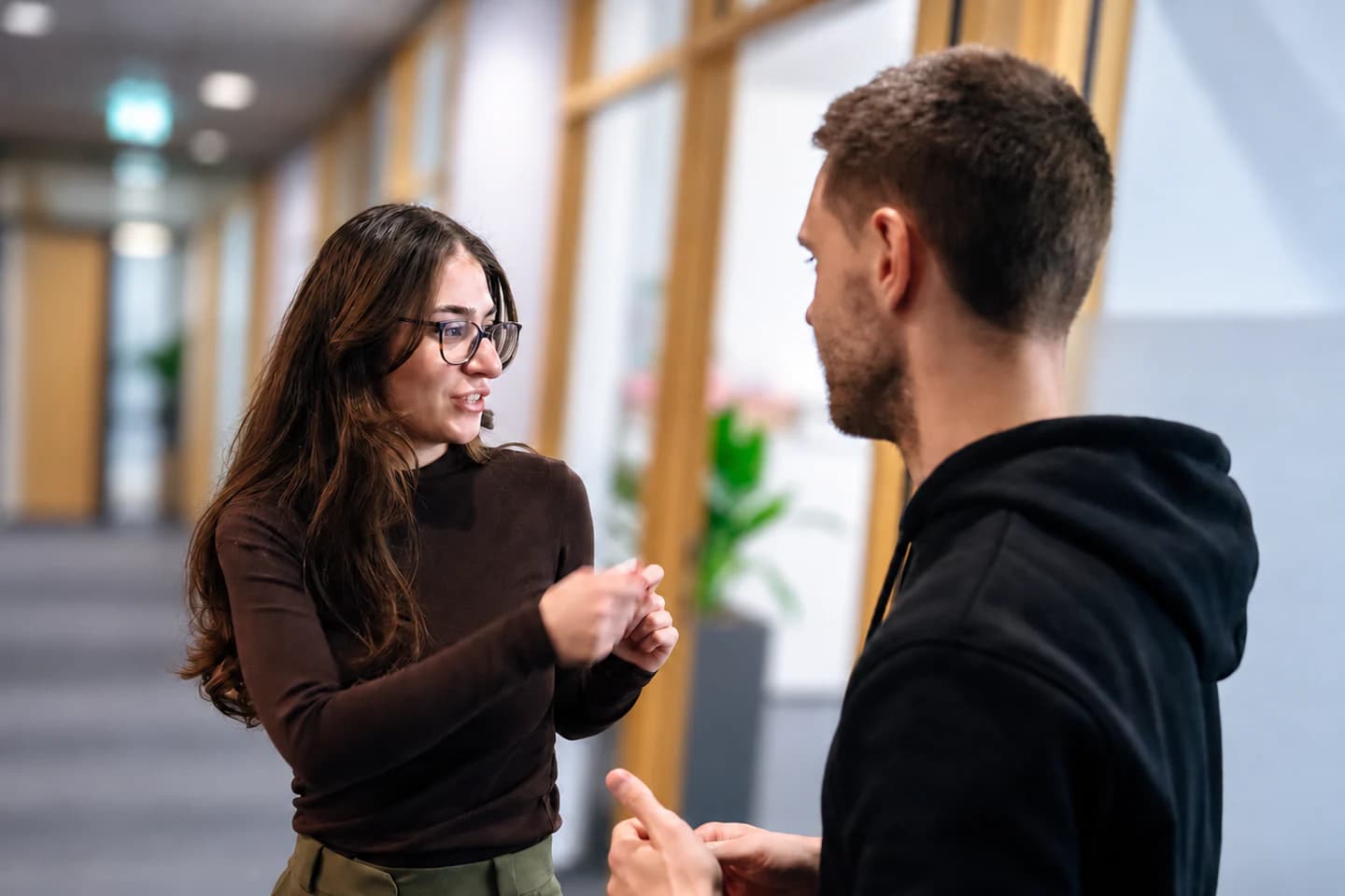 Two FrontWell colleagues exchanging ideas in the office.